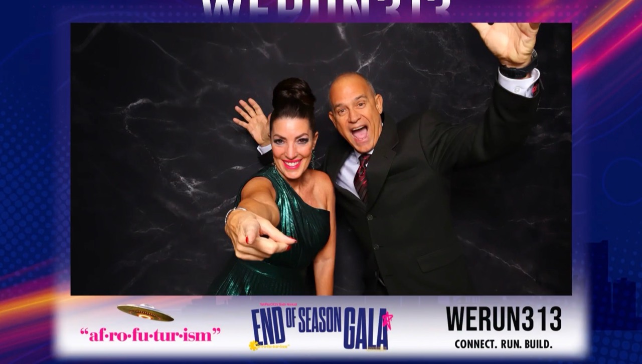Two gala guests posing in a custom Black Pepper Booth frame